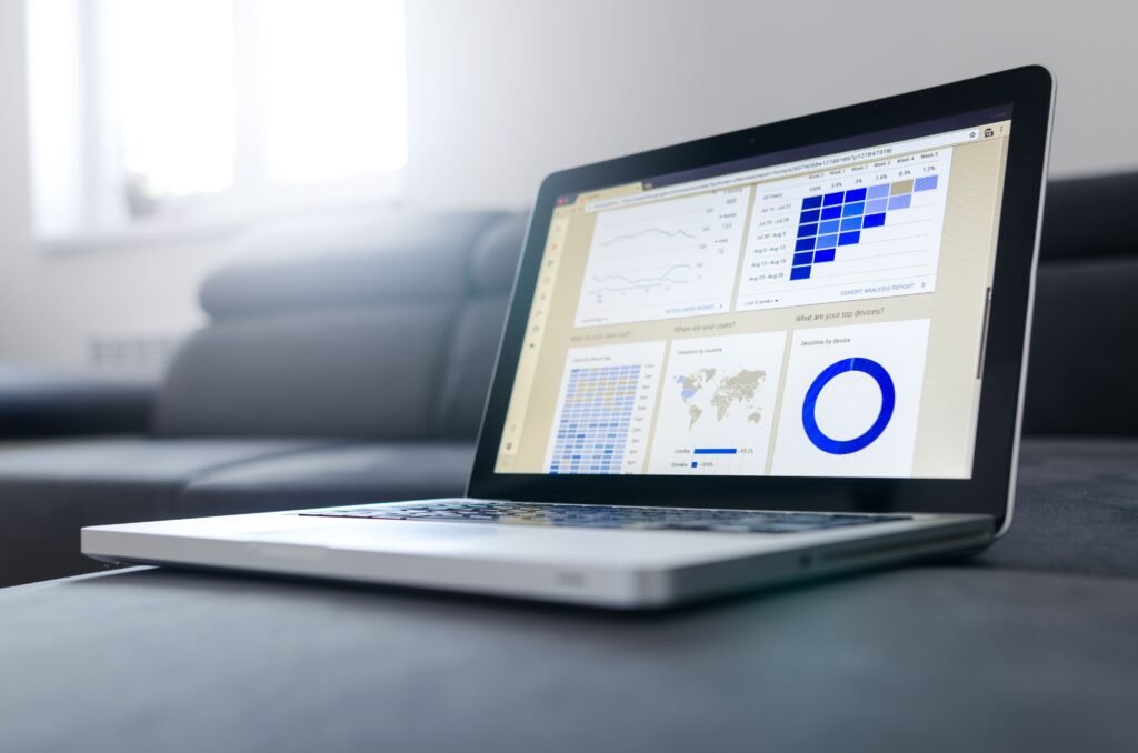 pexels-photo-577210-577210 Sleek laptop showcasing data analytics and graphs on the screen in a bright room.